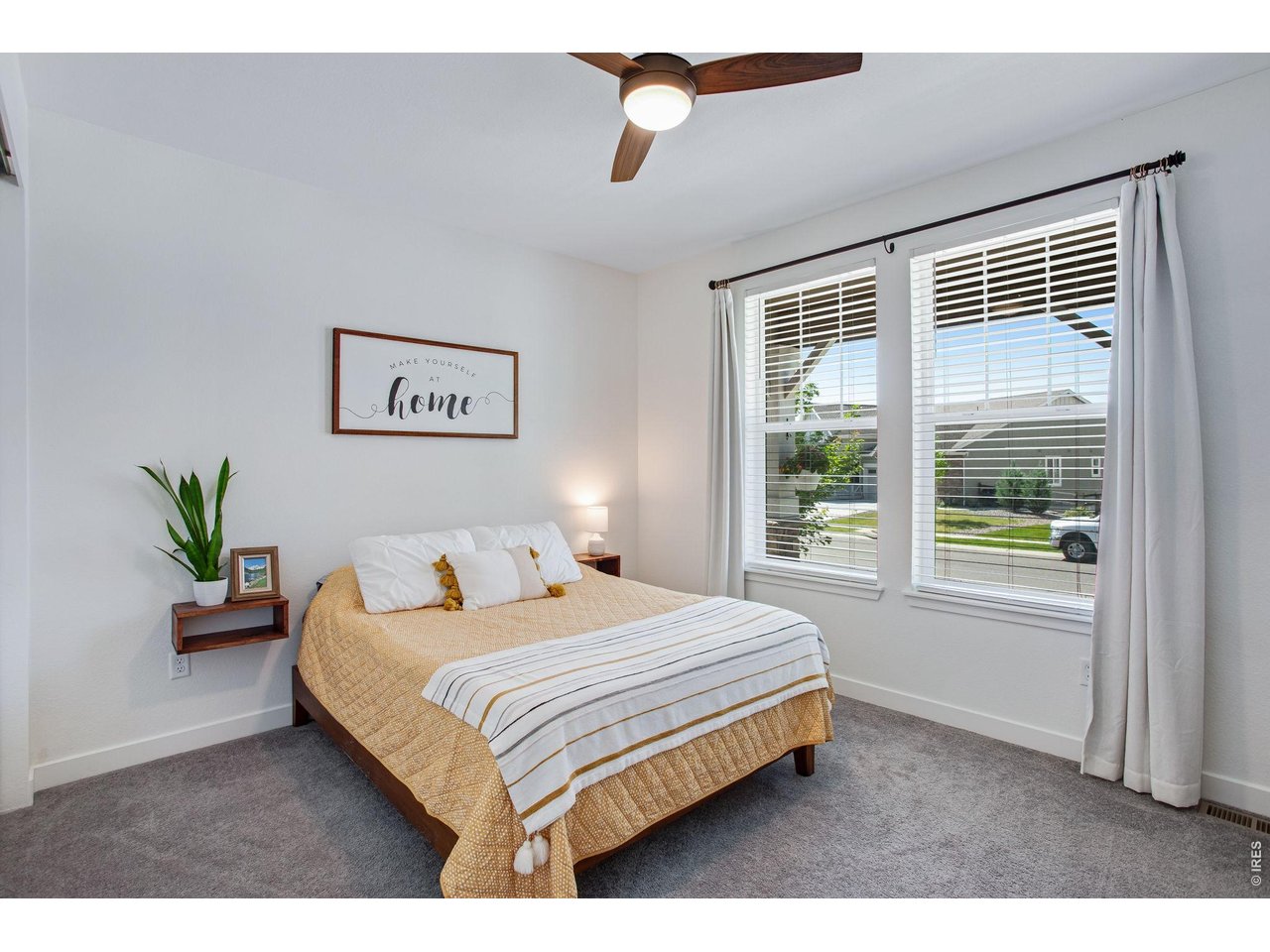Property Photo 29 front guest room (bedroom 3) with large windows and an upgraded ceiling fan