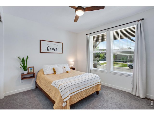 Property Photo 29 front guest room (bedroom 3) with large windows and an upgraded ceiling fan