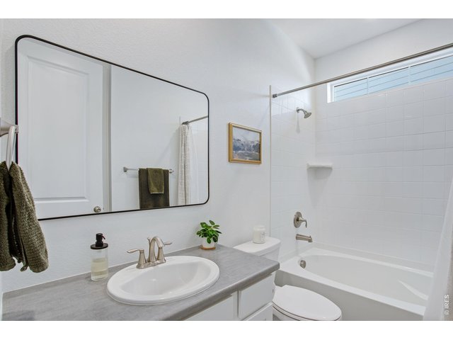 Property Photo 31 bathroom adjacent to rooms 2&3, upgraded mirror and window, full tub