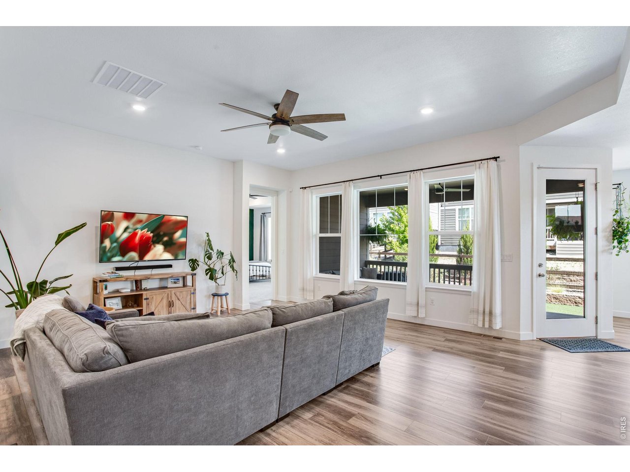 Property Photo 15 oversized picture windows, upgraded can lighting and ceiling fan