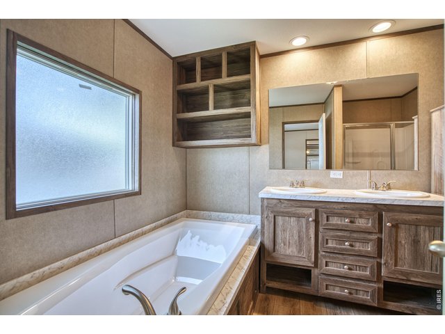 Property Photo 12 This primary en suite bathroom offers a spa-like retreat, featuring elegant finishes, a spacious layout, and a luxurious soaking atmosphere.