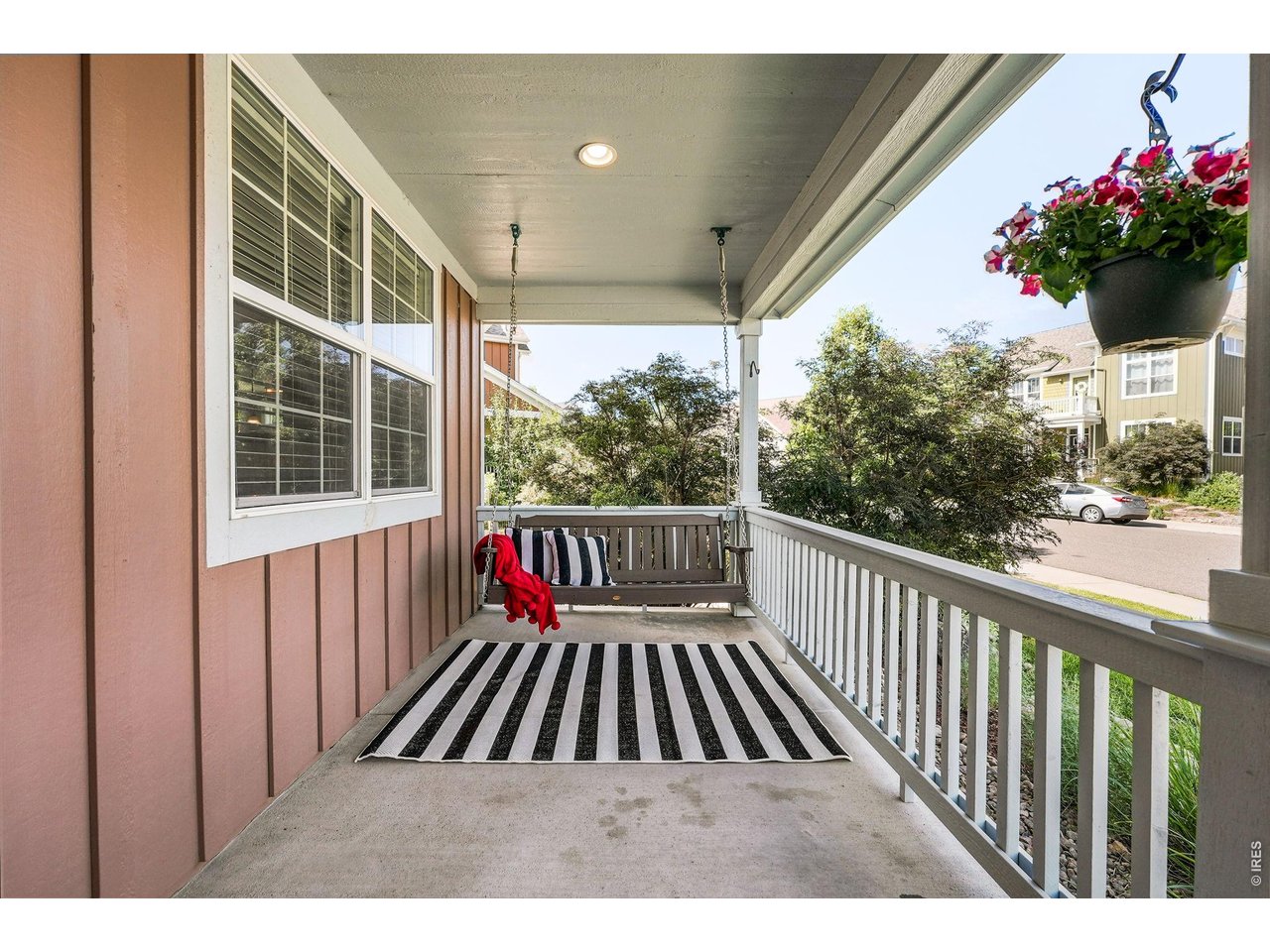 A charming covered front porch with a porch swing creates a warm welcome