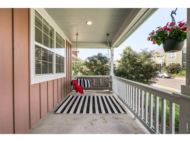 Property Photo 4 A charming covered front porch with a porch swing creates a warm welcome