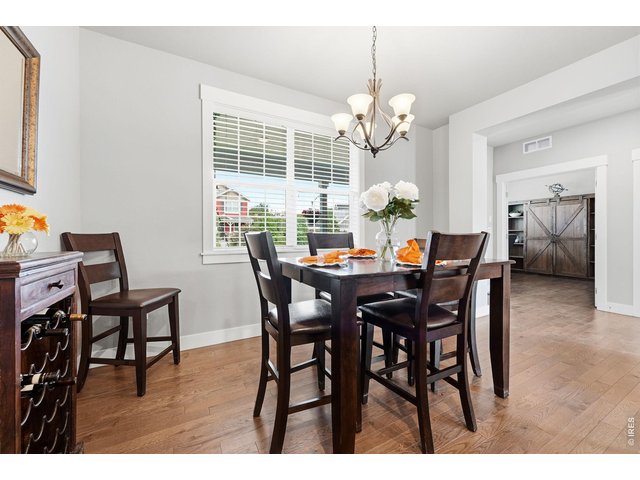 Property Photo 12 The gourmet kitchen is designed for both everyday living and entertaining, featuring a gas cooktop, center island with breakfast bar, ample cabinetry, and dining area.