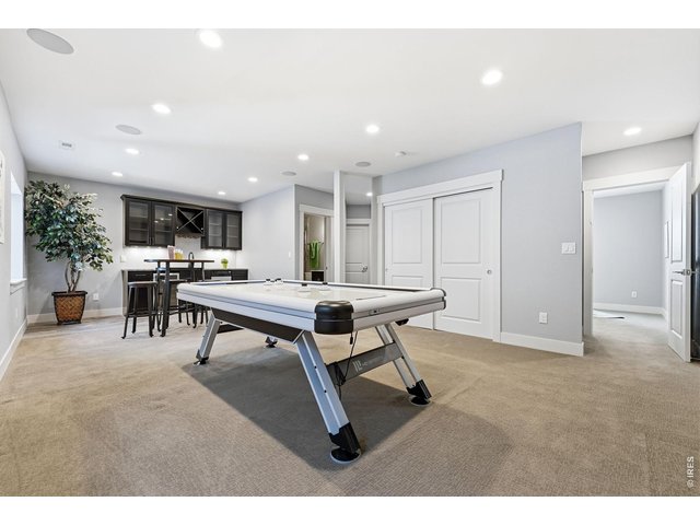 Property Photo 27 Large recreation room in basement complete with a wet bar, dishwasher, mini refrigerator