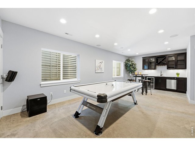 Property Photo 28 Large recreation room in basement complete with a wet bar, dishwasher, mini refrigerator