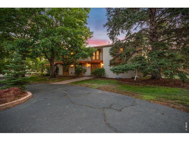 Property Photo 4 Expansive front courtyard and mature landscaping create a warm first impression.