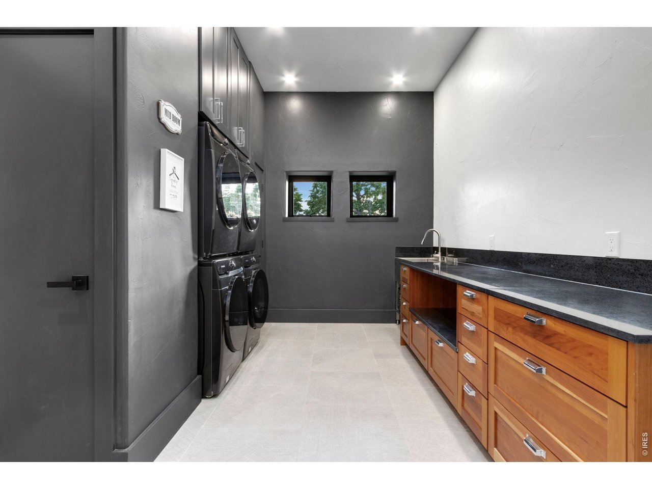 Property Photo 13 Oversized Laundry with 2 washers/ 2 dryers, Utility sink, storage and folding area.