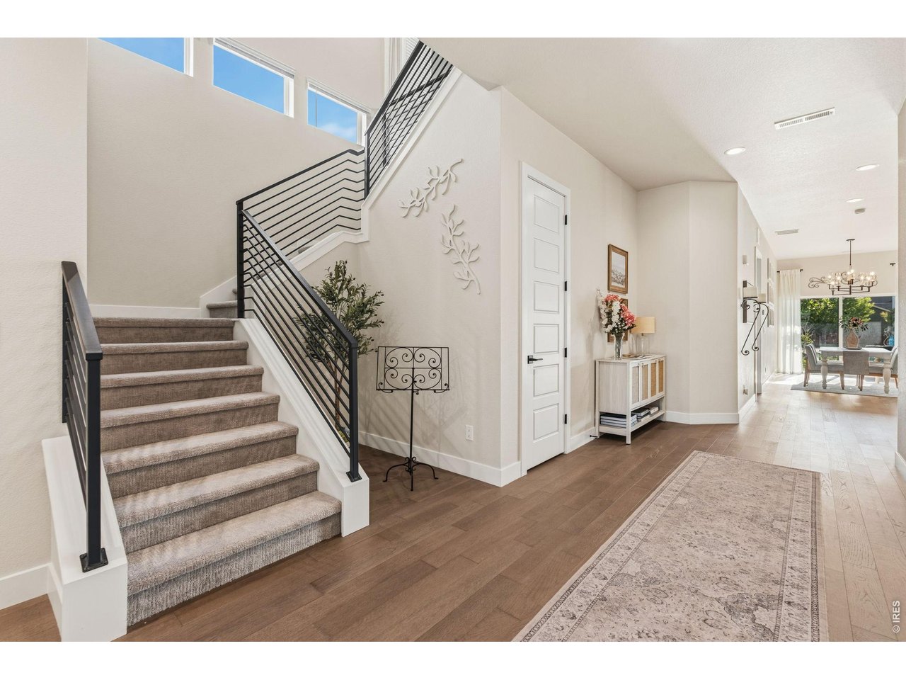 Property Photo 4 Spacious foyer with engineered hardwood flooring and modern finishes welcomes guests.