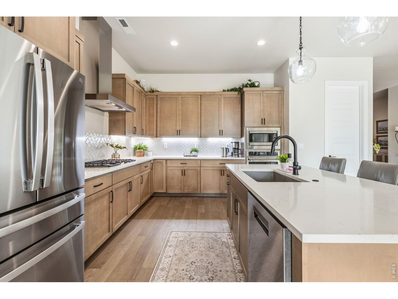 Property Photo 11 The gourmet kitchen is truly the heart of the home. Under-cabinet lighting creates both function and ambiance. Upgraded stainless steel appliances complete this chef-inspired kitchen.
