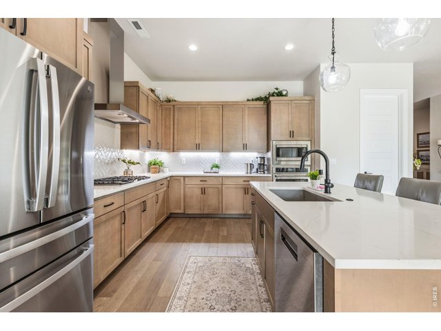 Property Photo 11 The gourmet kitchen is truly the heart of the home. Under-cabinet lighting creates both function and ambiance. Upgraded stainless steel appliances complete this chef-inspired kitchen.