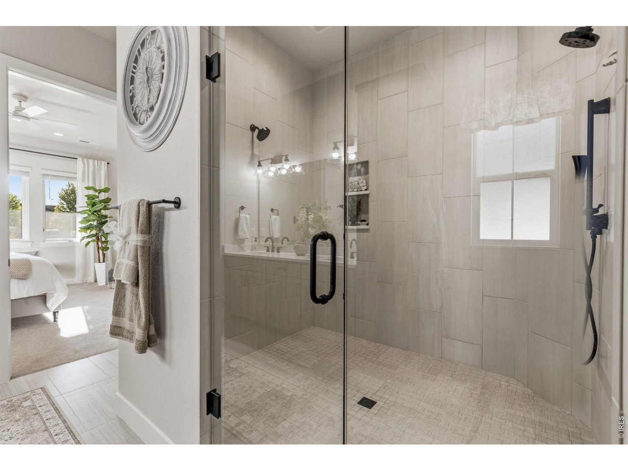 Property Photo 20 Oversized walk-in shower features dual shower heads plus a handheld upgrade.