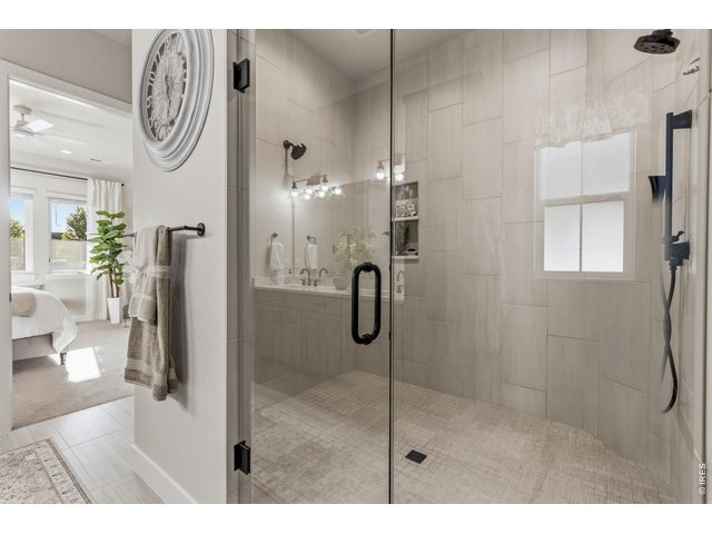 Property Photo 20 Oversized walk-in shower features dual shower heads plus a handheld upgrade.