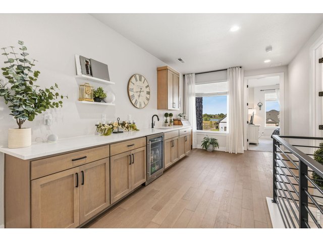 Property Photo 30 Wet bar with beverage refrigerator makes entertaining effortless.