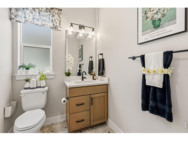 Property Photo 34 Secondary bathroom continues the home's upscale finishes with quartz and matte black fixtures.