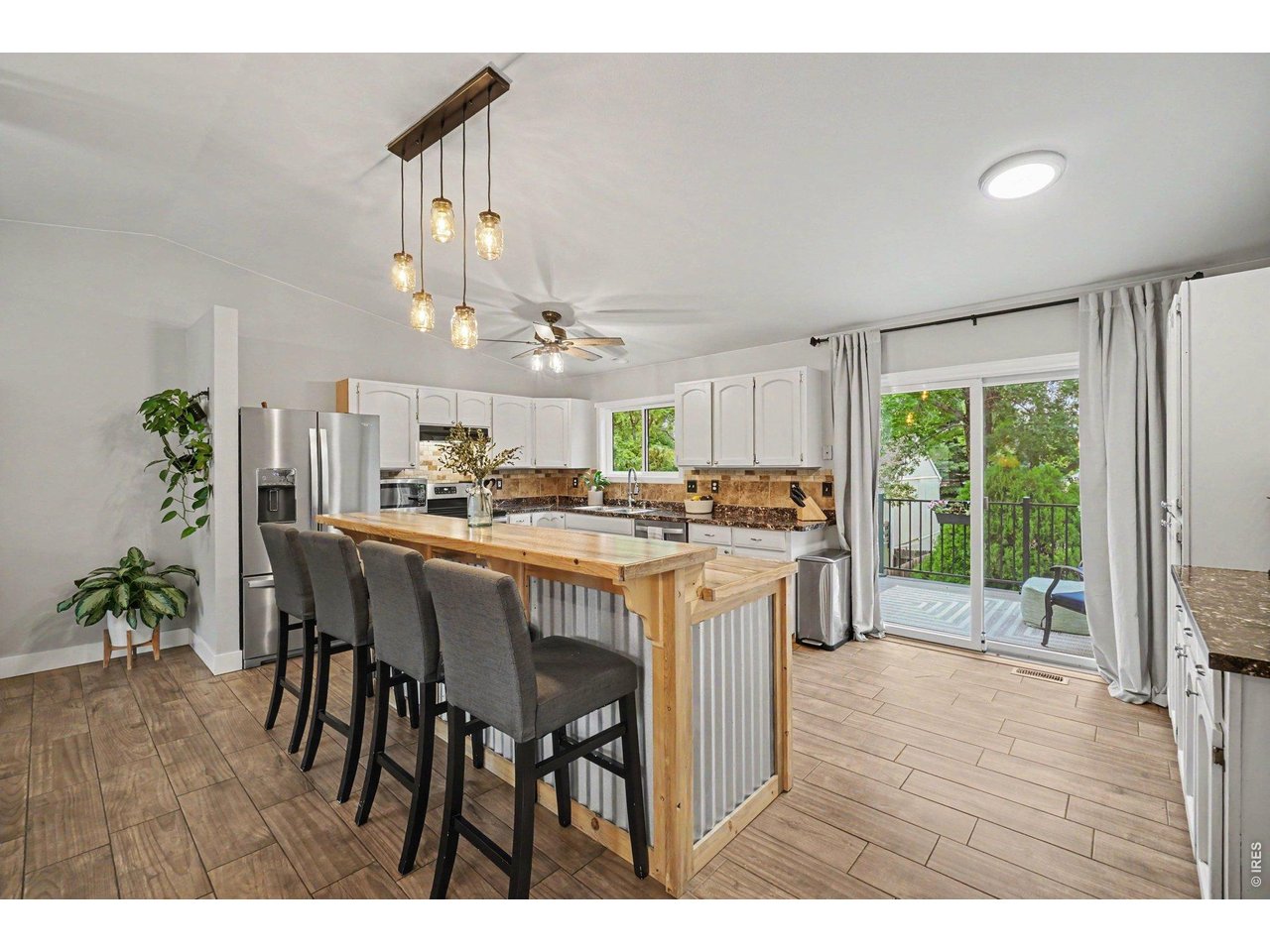 Property Photo 8 Sliding glass doors offer effortless access from the kitchen to a private balcony deck.