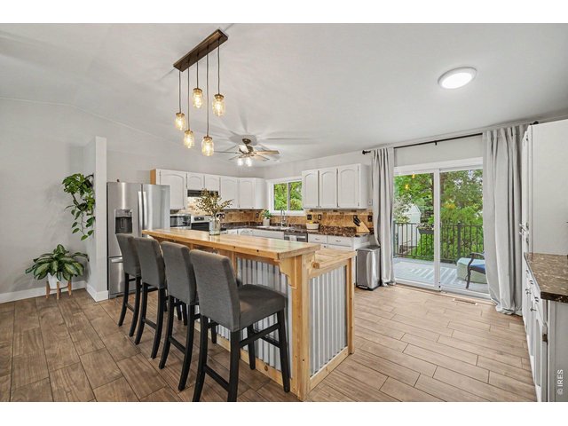 Property Photo 8 Sliding glass doors offer effortless access from the kitchen to a private balcony deck.