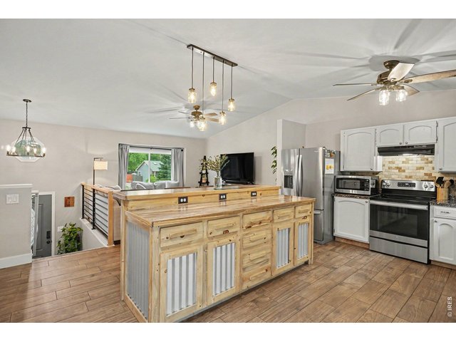 Property Photo 9 Deep, custom built-in drawers and integrated power outlets build maximum utility into the island.