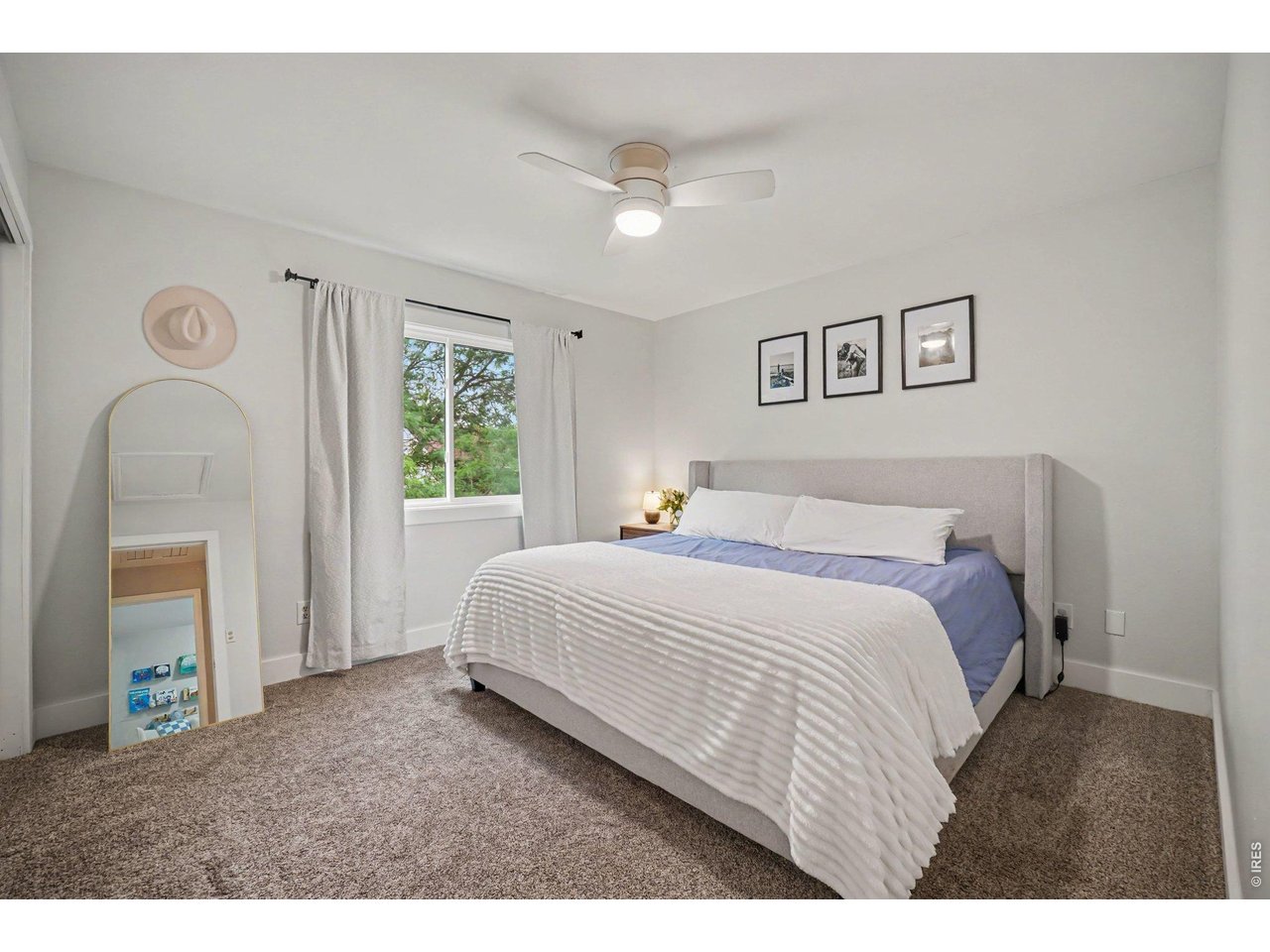 Property Photo 13 Primary bedroom layout highlighted by a bright window, clean finishes, and ample space for a full suite of furniture.