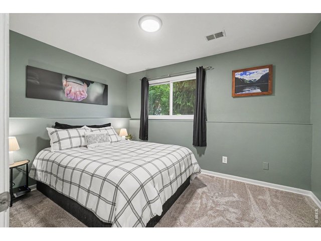 Property Photo 23 Features on-trend sage green accent walls, a crisp accent ledge, and comfortable plush carpeting.