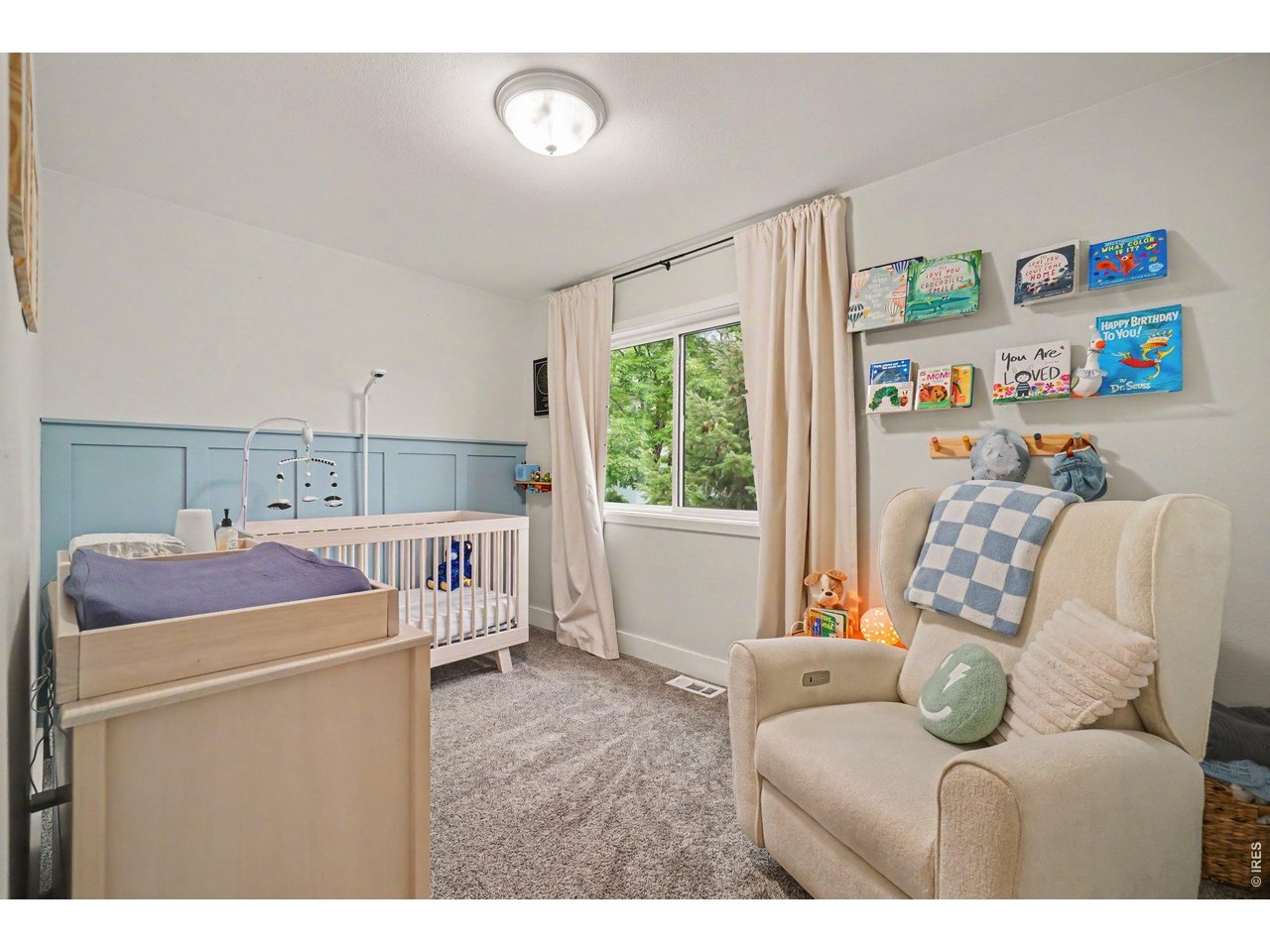 Property Photo 18 Custom soft-blue board-and-batten accent wall, built-in display shelving, and a flexible layout.