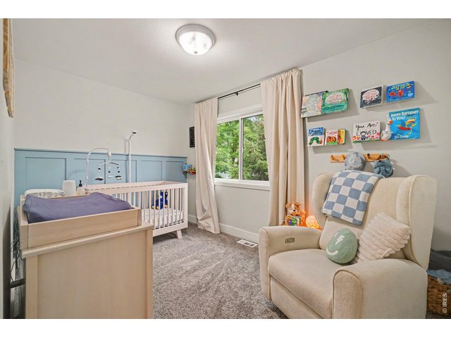 Property Photo 18 Custom soft-blue board-and-batten accent wall, built-in display shelving, and a flexible layout.