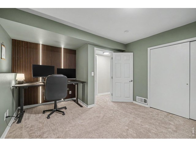 Property Photo 24 3rd Bedroom designed for productivity, featuring on-trend sage green walls and a striking wood-slat accent wall with integrated LED backlighting