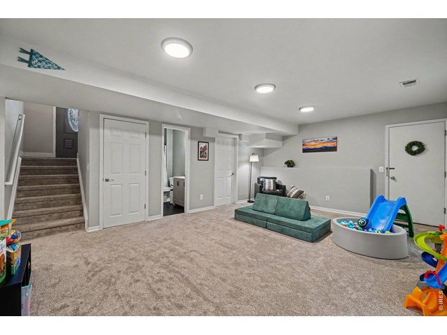 Property Photo 19 Massive finished basement providing the ultimate footprint for a game room, home theater, or kids' play zone with bright recessed lighting.