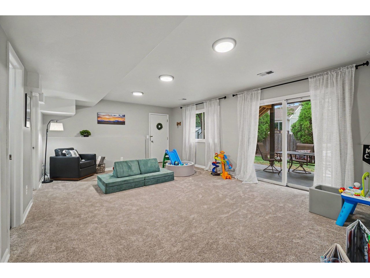 Property Photo 20 A rare, bright walk-out basement layout featuring large sliding glass doors that open directly to the covered patio and backyard.