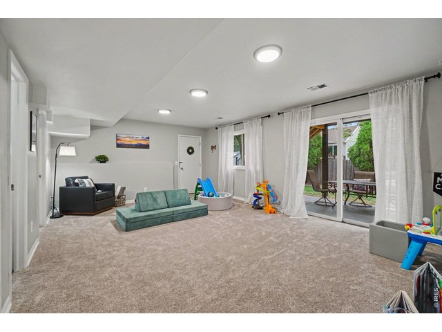 Property Photo 20 A rare, bright walk-out basement layout featuring large sliding glass doors that open directly to the covered patio and backyard.