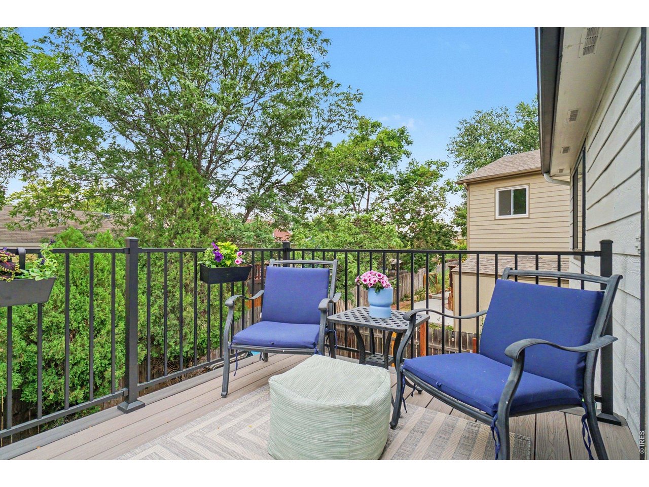 Property Photo 28 Private upper-level deck featuring low-maintenance composite flooring, secure black metal railings, and plenty of space for cozy outdoor seating.