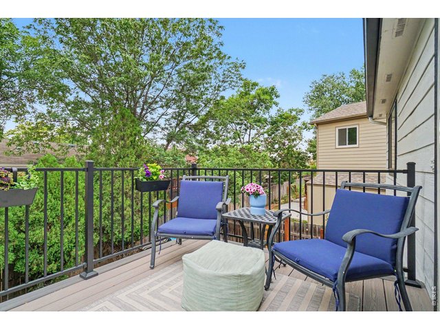 Property Photo 28 Private upper-level deck featuring low-maintenance composite flooring, secure black metal railings, and plenty of space for cozy outdoor seating.