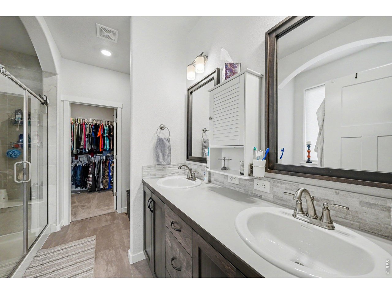 Property Photo 13 Primary Bath with double sinks, large shower, tub and walk-in closet