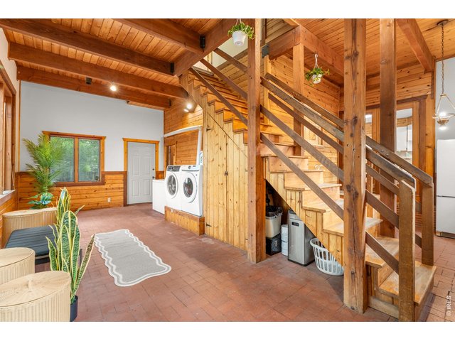 Property Photo 27 Sunroom with Laundry and Deep Freezer. It is heated for the winter.