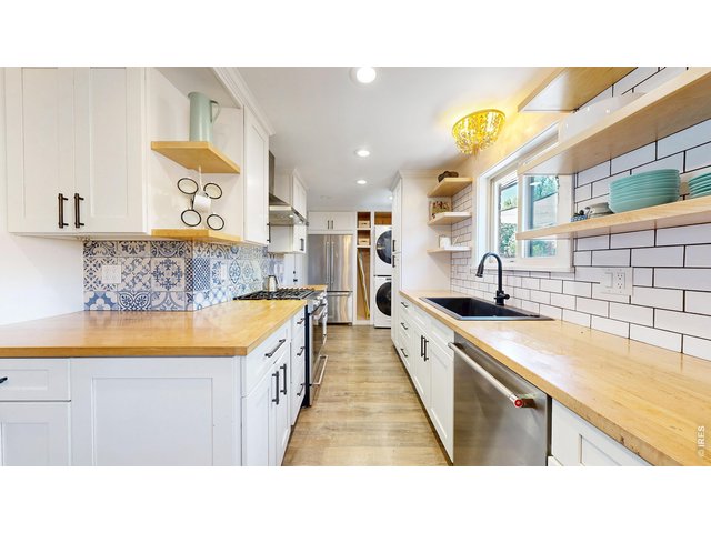 Property Photo 9 Open and closed cabinet spaces, gorgeous backsplashes, all stainless appliances