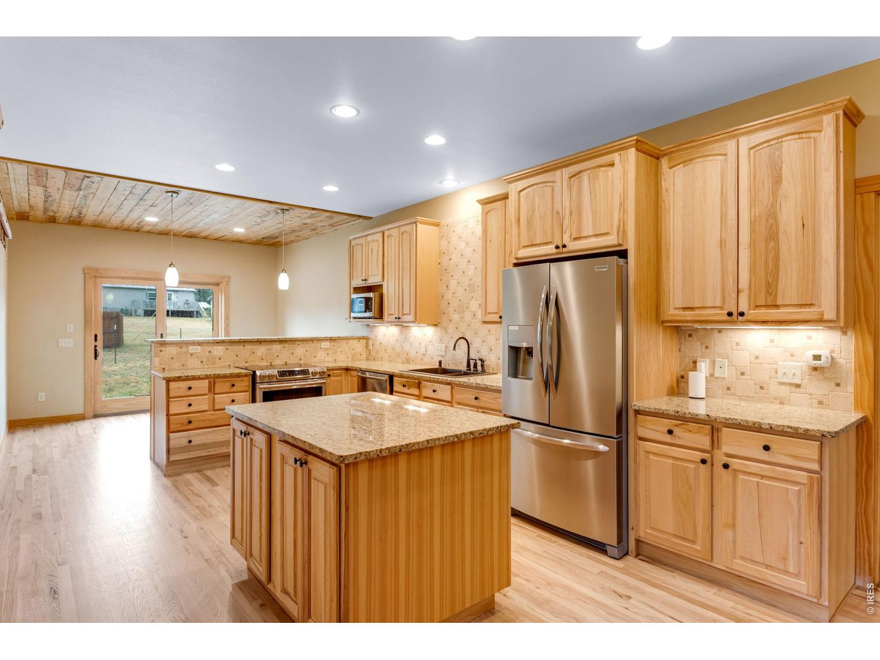 Property Photo 2 Warm and inviting chef's kitchen complete with induction oven and granite counter tops.