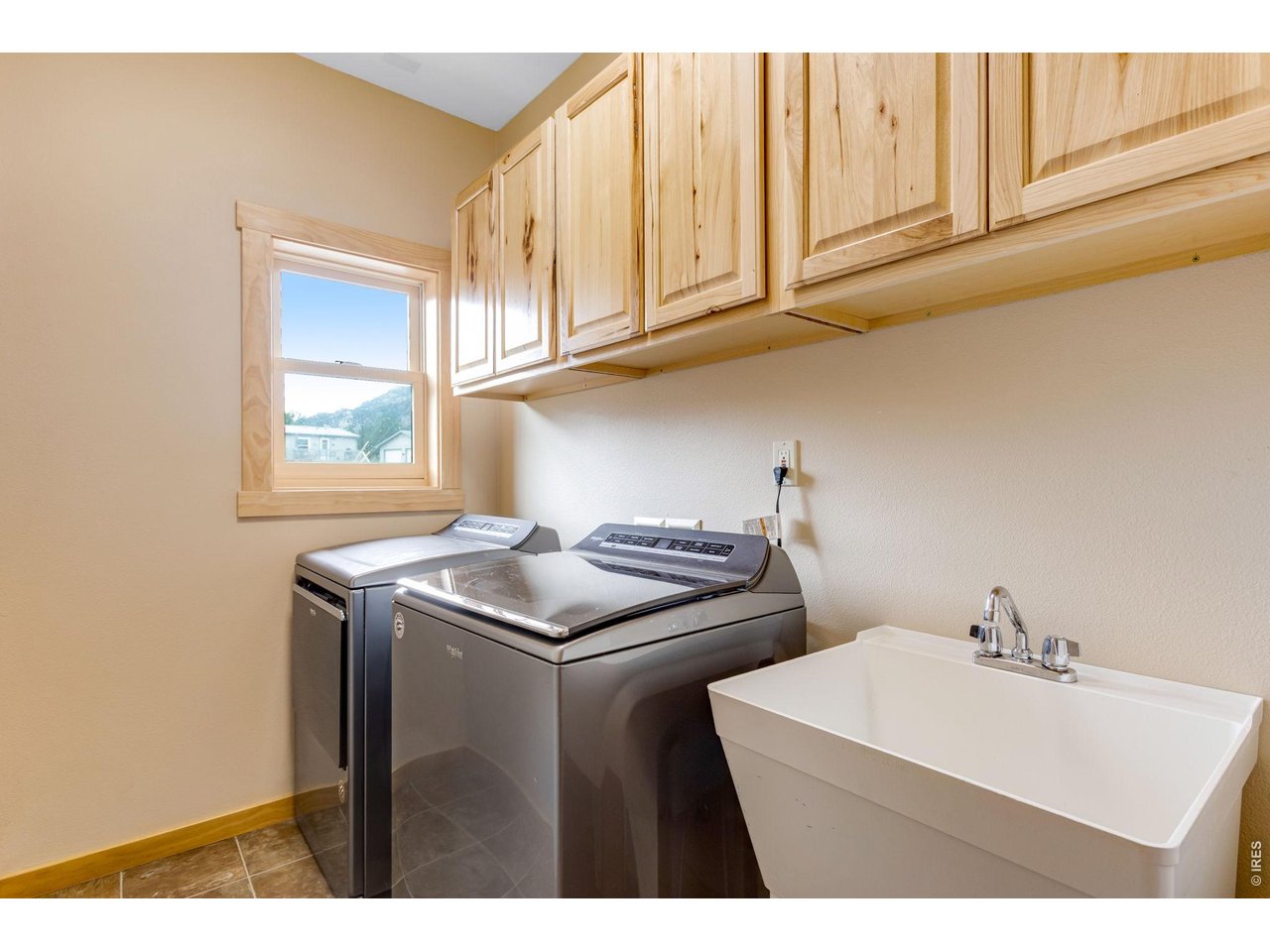 Property Photo 28 Main level laundry room with sink and plenty of storage.