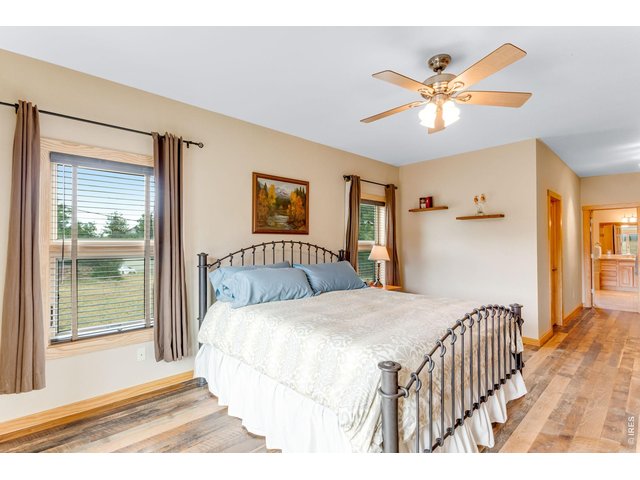 Property Photo 4 Real barnwood flooring in the huge primary suite on the main floor with walk in closet.