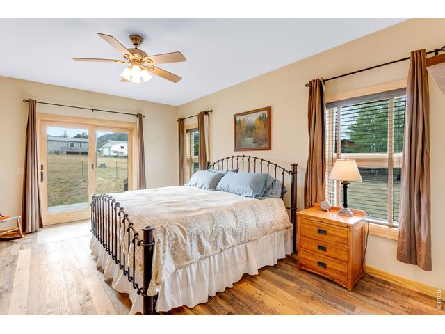 Property Photo 23 Main level primary bedroom with glass sliding door to patio.