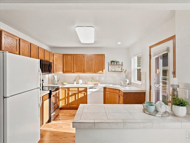 Property Photo 12 kitchen with great counter space and backdoor access to the garage and carport