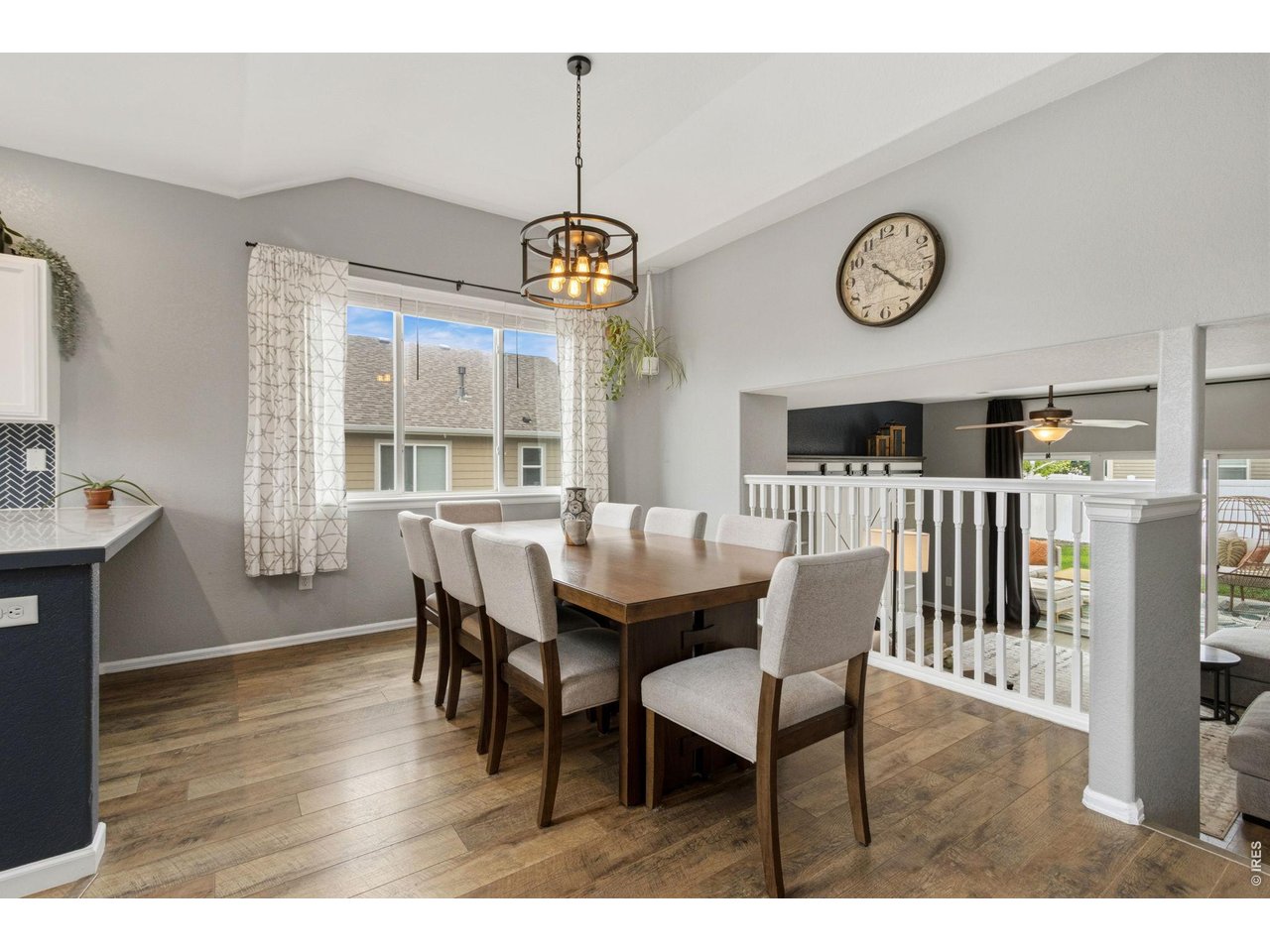 Property Photo 4 The dining room overlooks the living area, creating a bright and connected space perfect for gathering with family and friends.