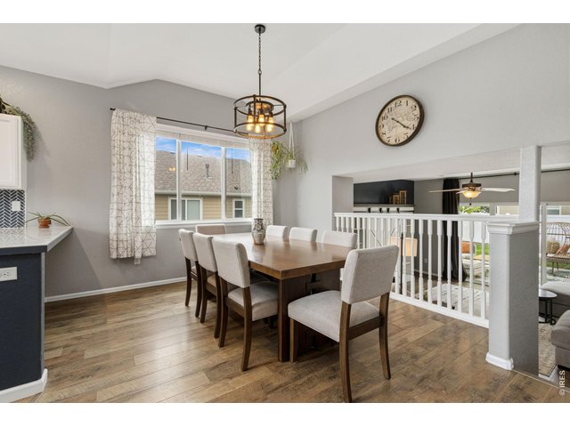 Property Photo 4 The dining room overlooks the living area, creating a bright and connected space perfect for gathering with family and friends.