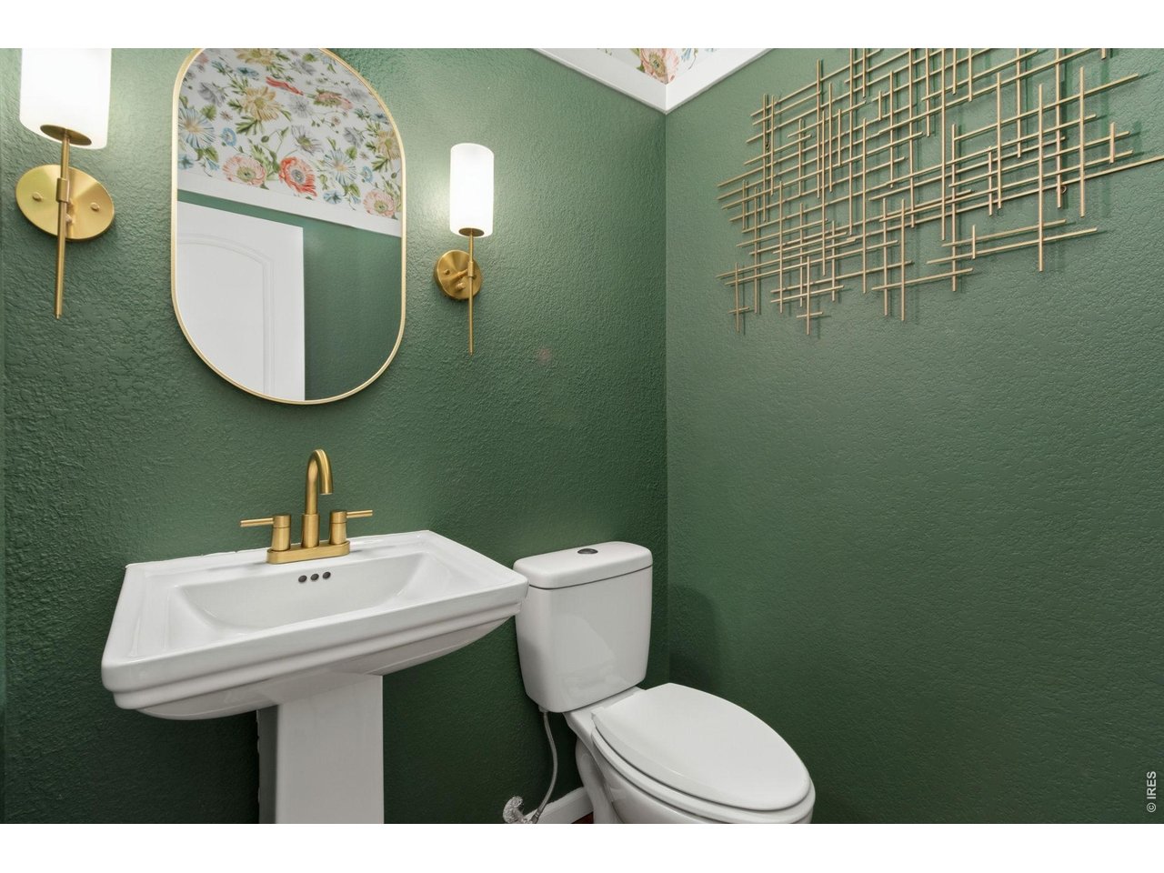 Property Photo 11 A beautifully designed powder room adds a touch of personality with rich color, modern fixtures, and designer finishes.