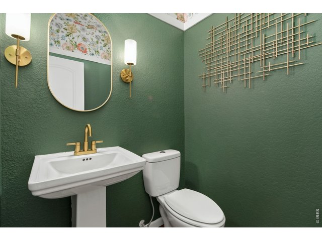 Property Photo 11 A beautifully designed powder room adds a touch of personality with rich color, modern fixtures, and designer finishes.