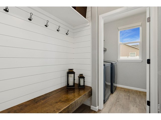 Property Photo 12 The perfect drop zone! Custom shiplap, built-in hooks, and bench seating create a functional everyday entry from the garage.
