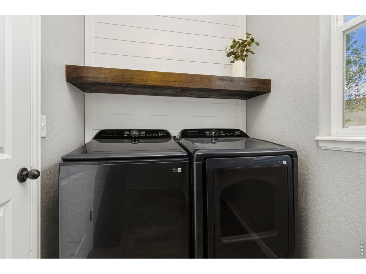 Property Photo 13 Bright and practical with custom shelving, included washer and dryer, and space to keep laundry organized.