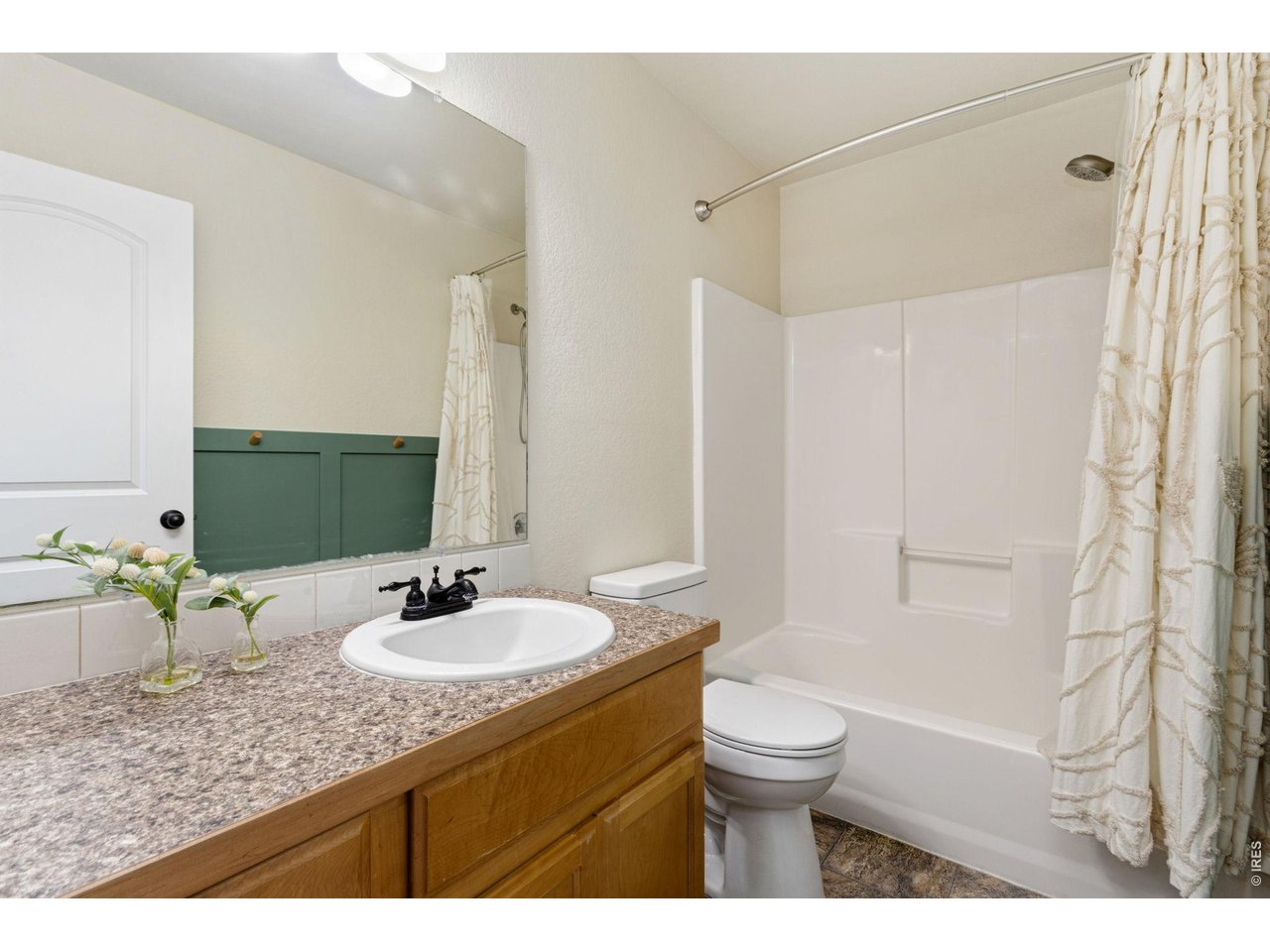 Property Photo 18 A full bathroom that easily serves the secondary bedrooms with plenty of counter space and a tub/shower combination.