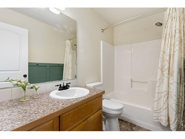Property Photo 18 A full bathroom that easily serves the secondary bedrooms with plenty of counter space and a tub/shower combination.