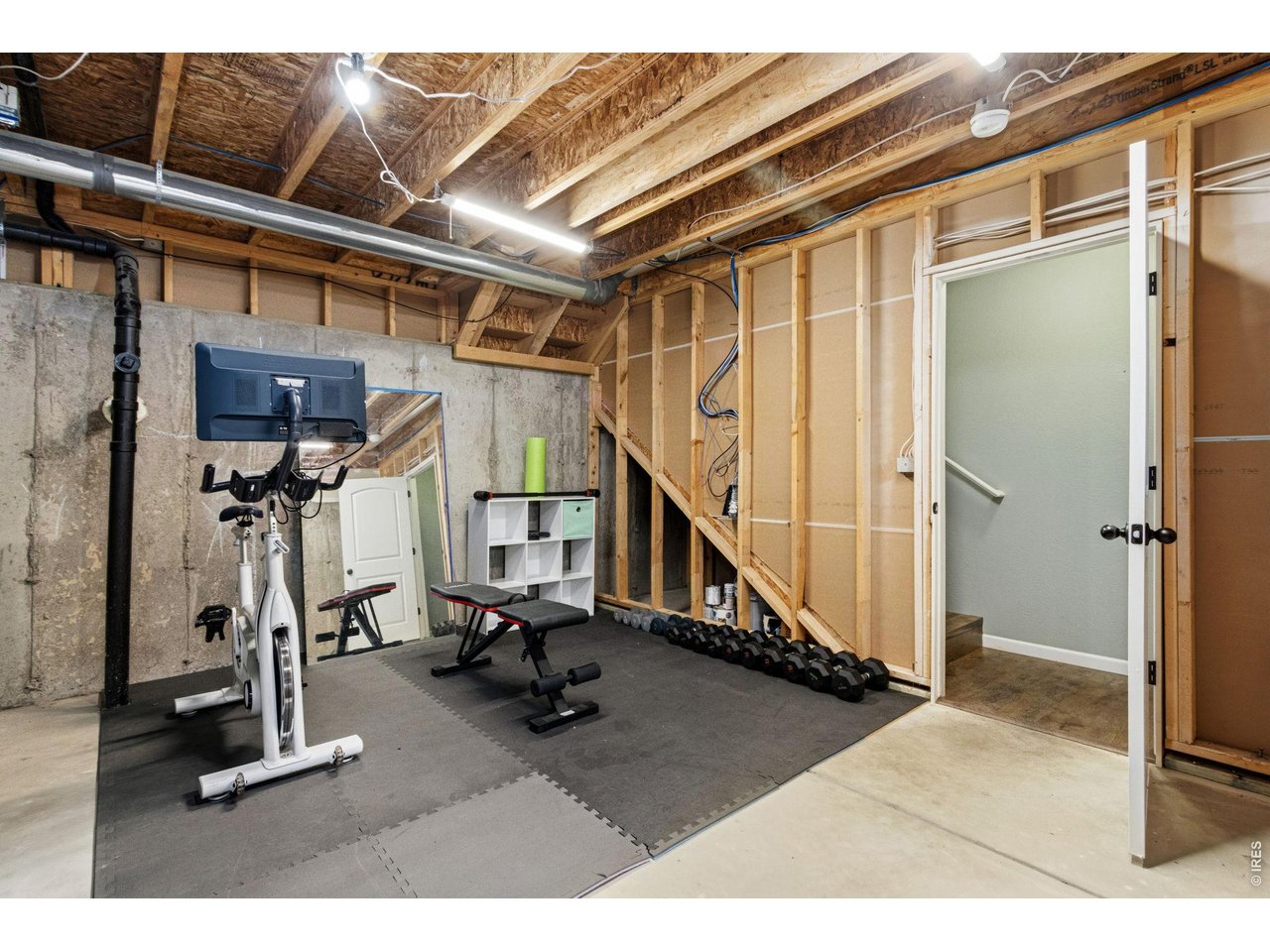 Property Photo 19 Ready for your vision! The unfinished basement offers potential for future living space, a home gym, recreation room, or abundant storage.