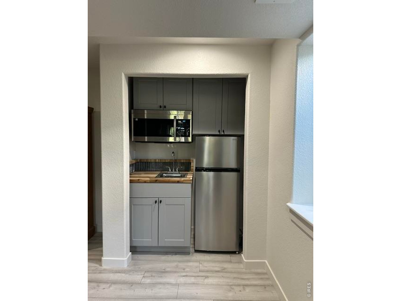 Property Photo 25 Kitchenette with wood counter top and metal backsplash. All appliances included.